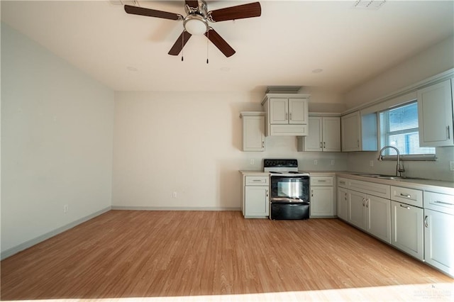 kitchen featuring electric range, sink, ceiling fan, ventilation hood, and light wood-type flooring