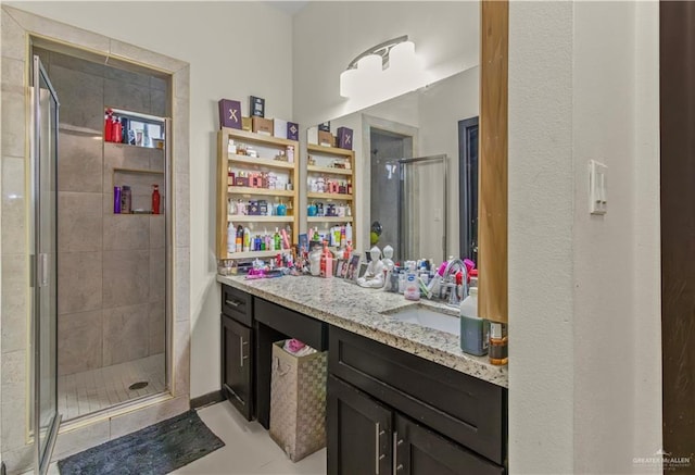 bathroom with tile patterned floors, vanity, and walk in shower