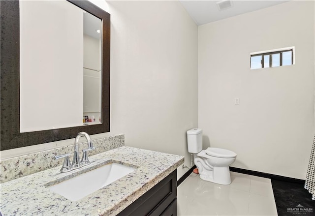 bathroom featuring tile patterned floors, vanity, and toilet