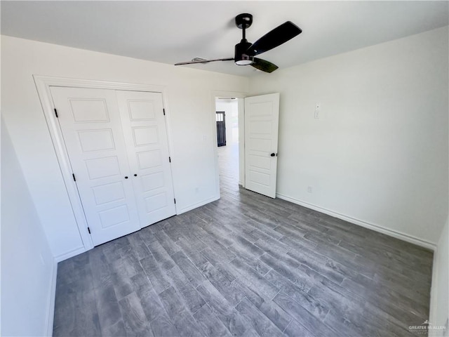 unfurnished bedroom featuring ceiling fan, a closet, and dark hardwood / wood-style flooring