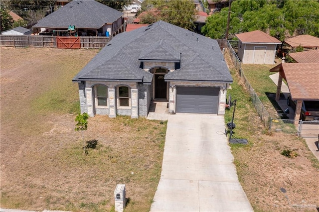 3525 Rancho Del Rey St, Edinburg, TX 78542 - french country inspired facade with an attached garage, a shingled roof, driveway, and fence