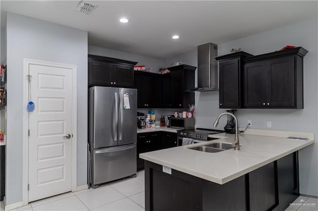 3525 Rancho Del Rey St, Edinburg, TX 78542 - kitchen with wall chimney range hood, a peninsula, visible vents, dark cabinetry, and stainless steel appliances
