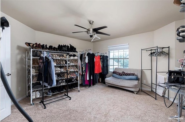 walk in closet with carpet and ceiling fan