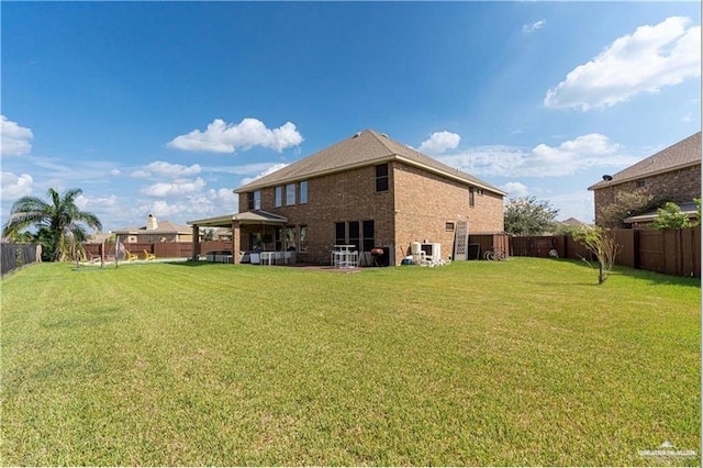 rear view of house with a yard