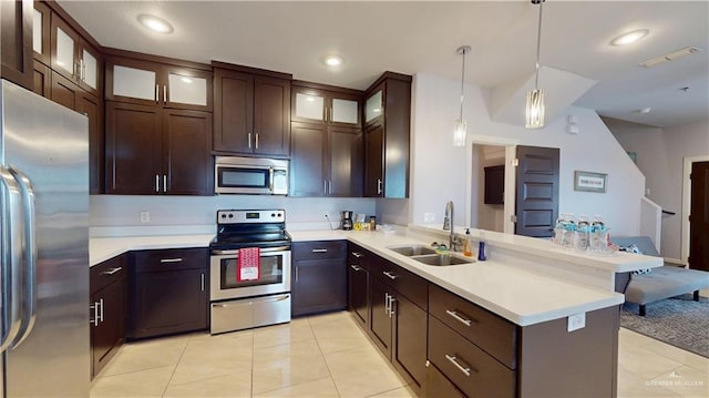 1208 E Camellia Ave Unit 2, Mcallen, TX 78501 - kitchen featuring dark brown cabinets, a sink, light countertops, a peninsula, and appliances with stainless steel finishes