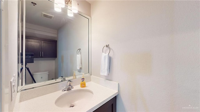 1208 E Camellia Ave Unit 2, Mcallen, TX 78501 - half bathroom with toilet, vanity, and visible vents