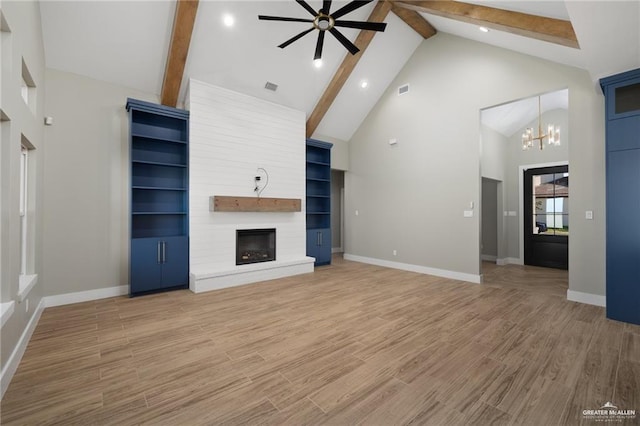 3404 Saint Honore Dr, Mcallen, TX 78504 - unfurnished living room featuring ceiling fan, beam ceiling, a large fireplace, high vaulted ceiling, and a chandelier