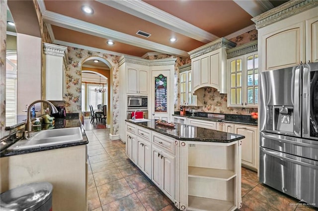 kitchen featuring sink, a center island, stainless steel appliances, and cream cabinetry