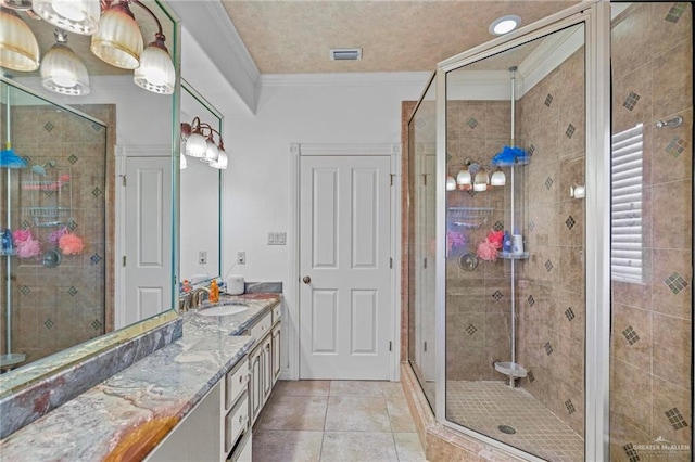 bathroom featuring tile patterned flooring, vanity, ornamental molding, and walk in shower