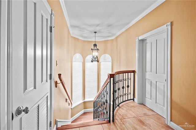 interior space with ornamental molding and a chandelier