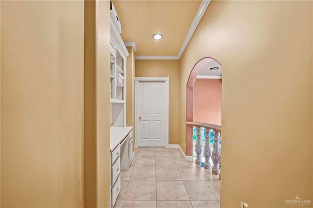 hallway featuring crown molding and light tile patterned flooring