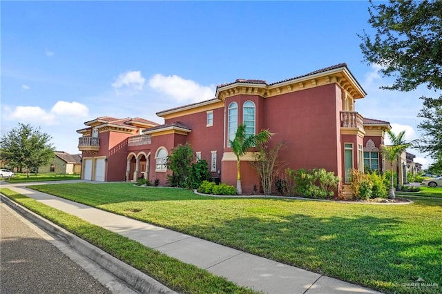 view of front of property with a garage and a front lawn