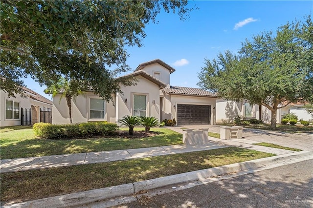 mediterranean / spanish-style house featuring a garage and a front lawn