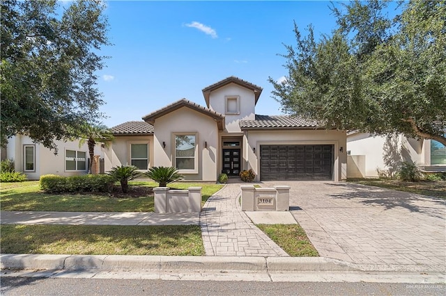 mediterranean / spanish house with a garage