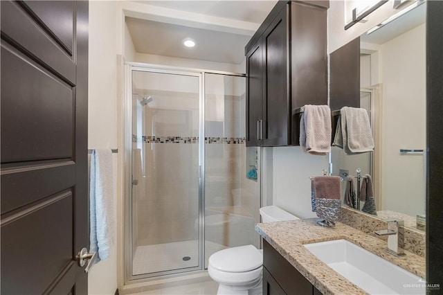 bathroom featuring vanity, toilet, and walk in shower