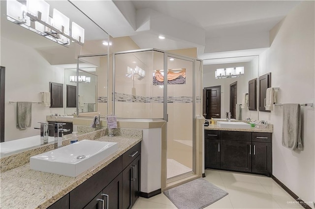 bathroom featuring tile patterned flooring, vanity, and a shower with door