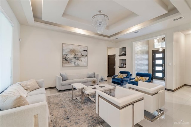 tiled living room with a notable chandelier and a raised ceiling