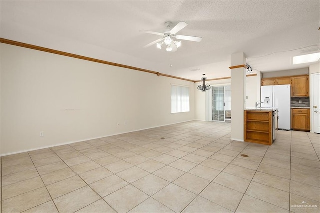 unfurnished living room featuring ceiling fan with notable chandelier, a textured ceiling, and light tile patterned floors