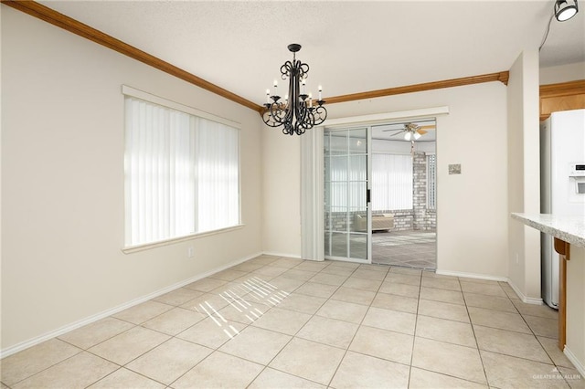 unfurnished dining area featuring ornamental molding, ceiling fan with notable chandelier, and light tile patterned floors