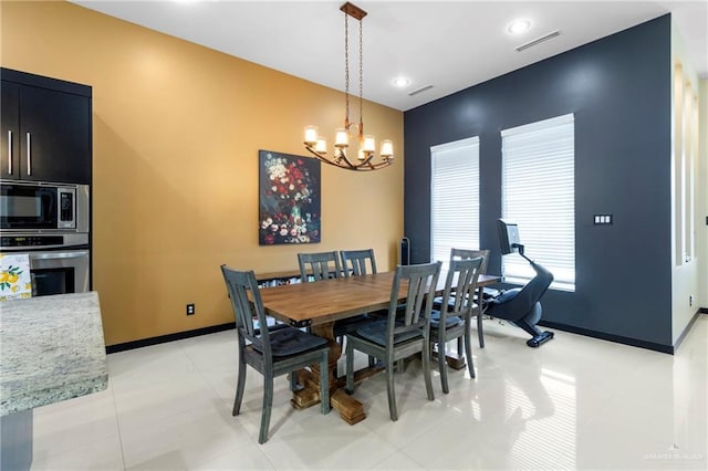 dining space with light tile patterned floors and a notable chandelier