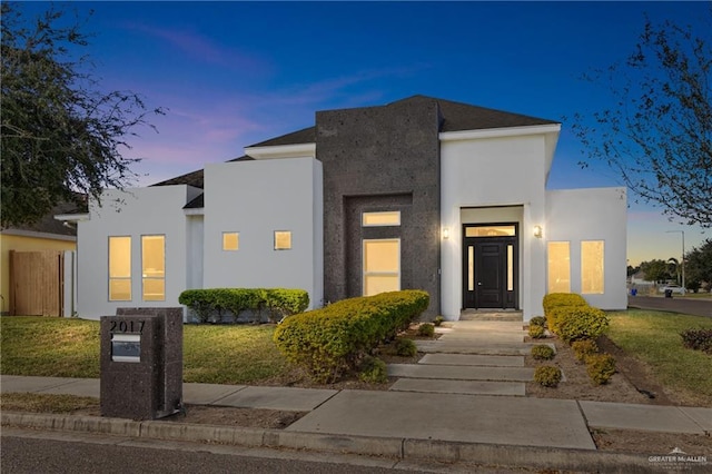 contemporary house with a lawn