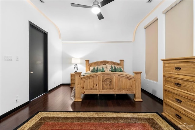 bedroom with dark hardwood / wood-style flooring and ceiling fan