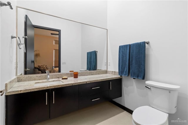 bathroom featuring tile patterned floors, vanity, and toilet