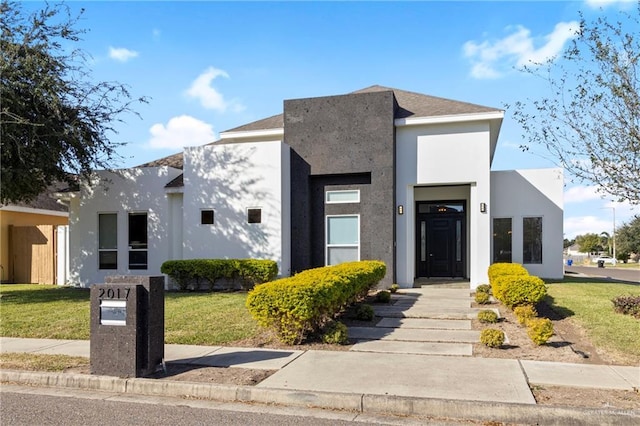 modern home with a front lawn