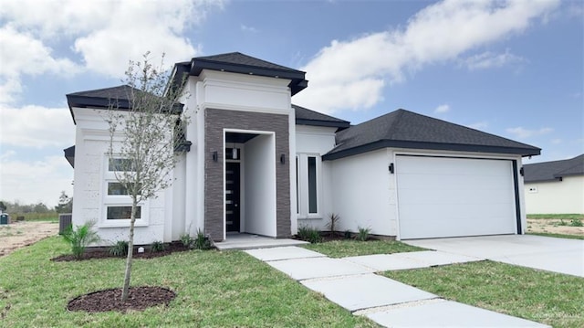 view of front of house with a front yard and a garage