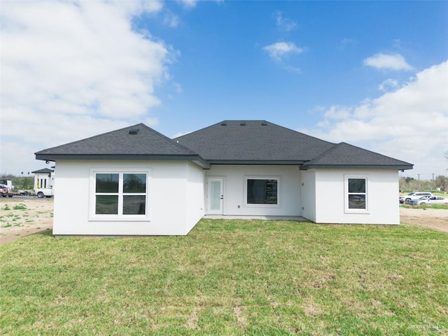 rear view of house featuring a yard