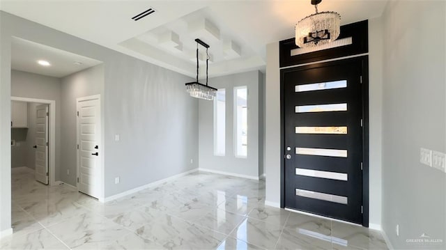 foyer featuring a raised ceiling