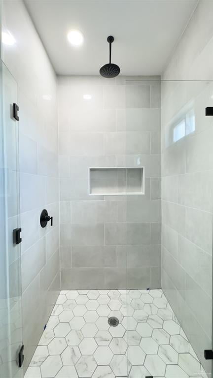 bathroom featuring a shower with shower door