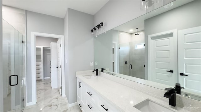 bathroom featuring a shower with shower door and vanity