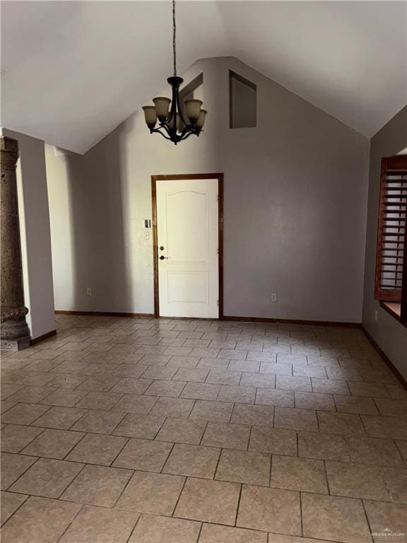 interior space with baseboards, a chandelier, and high vaulted ceiling
