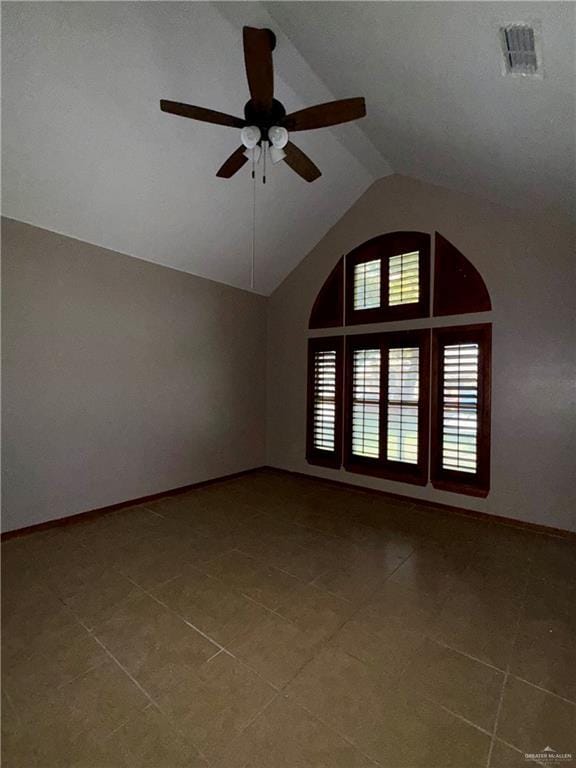 spare room featuring tile patterned flooring, visible vents, baseboards, high vaulted ceiling, and a ceiling fan