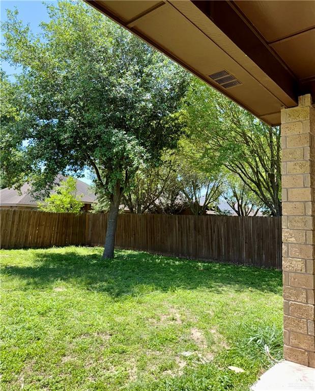 view of yard featuring fence and visible vents