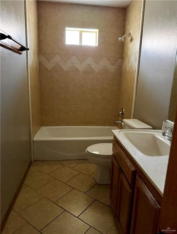full bath featuring tile patterned floors, vanity, toilet, and bathing tub / shower combination