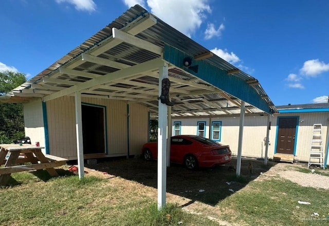 view of vehicle parking with a yard