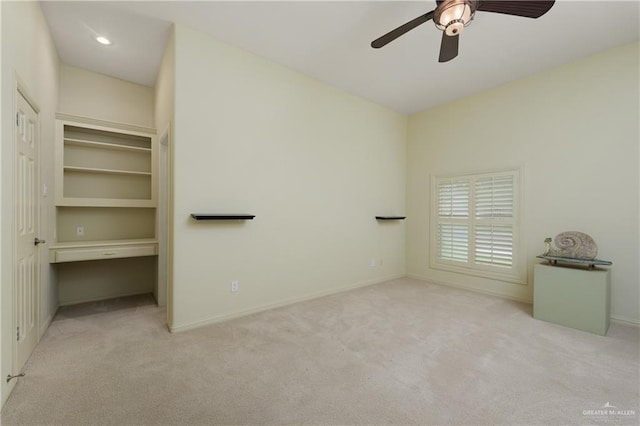 unfurnished bedroom with ceiling fan, a closet, and light colored carpet