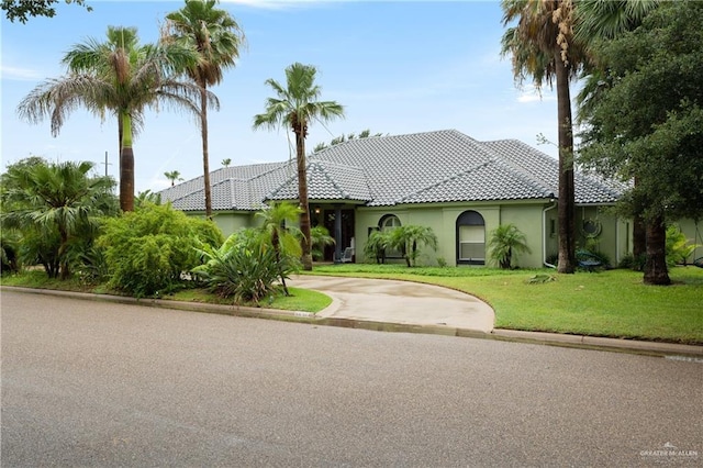 mediterranean / spanish house featuring a front lawn