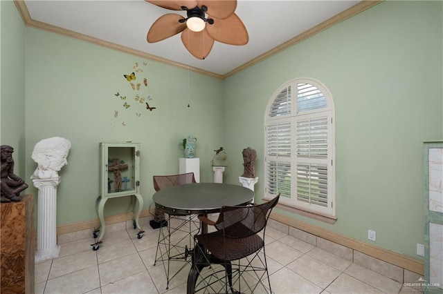 tiled dining room with crown molding and ceiling fan