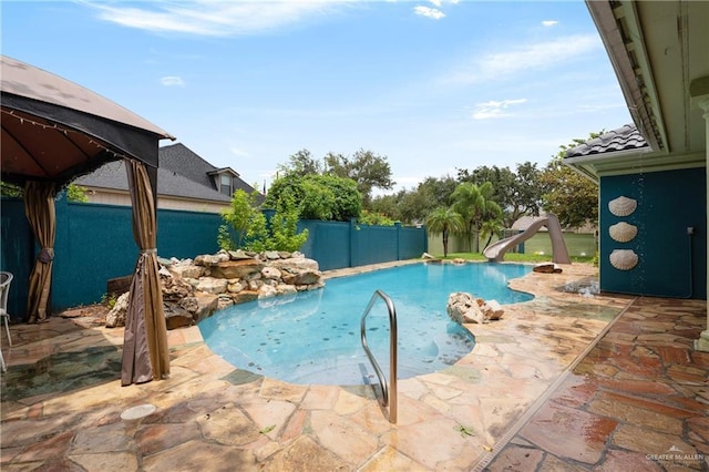 view of pool with a patio and a water slide