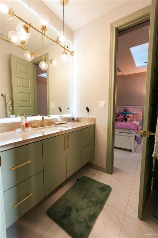 2511 Wisteria St, Mission, TX 78574 - ensuite bathroom featuring a skylight and double vanity