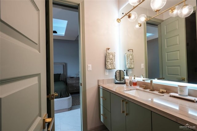 2511 Wisteria St, Mission, TX 78574 - bathroom with marble finish floors, vanity, connected bathroom, and a skylight