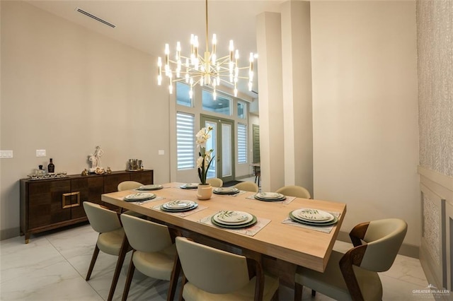 2511 Wisteria St, Mission, TX 78574 - dining room with light marble finish flooring and a chandelier