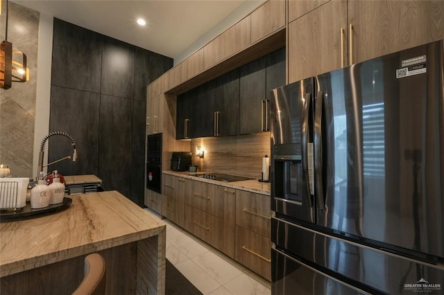 2511 Wisteria St, Mission, TX 78574 - kitchen with black appliances, light marble finish floors, a sink, modern cabinets, and recessed lighting