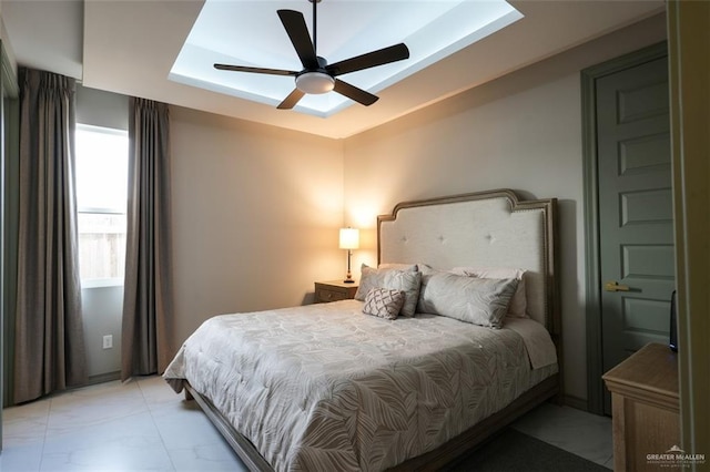 2511 Wisteria St, Mission, TX 78574 - bedroom featuring light marble finish floors, a tray ceiling, and ceiling fan