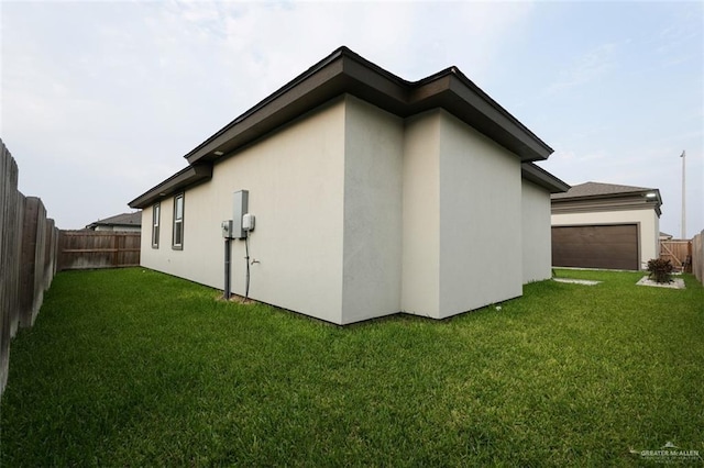 2511 Wisteria St, Mission, TX 78574 - view of side of property featuring stucco siding and a garage
