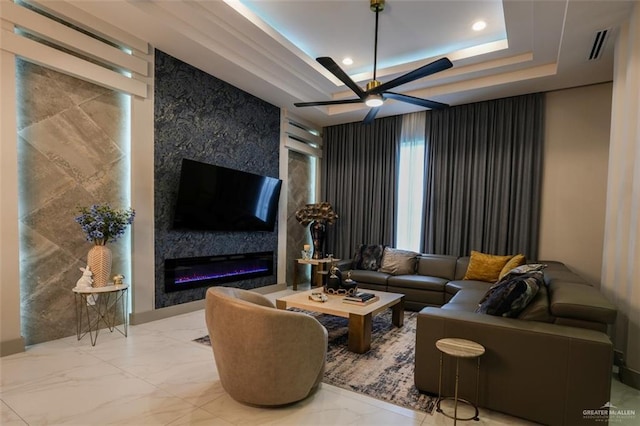 2511 Wisteria St, Mission, TX 78574 - living area featuring ceiling fan, a raised ceiling, a fireplace, marble finish floors, and recessed lighting