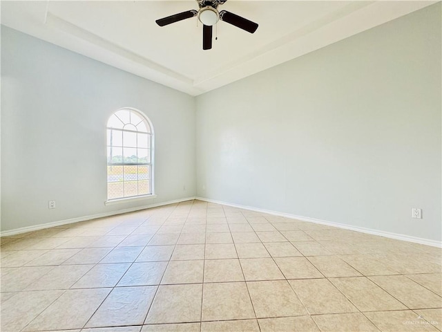 tiled spare room with ceiling fan